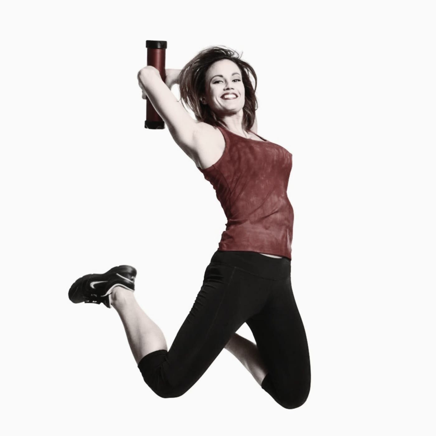 Woman celebrating mid-jump after an Axion Trainer workout